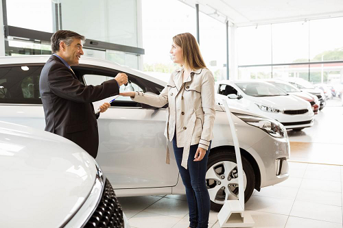 Auto Dealer handing woman keys